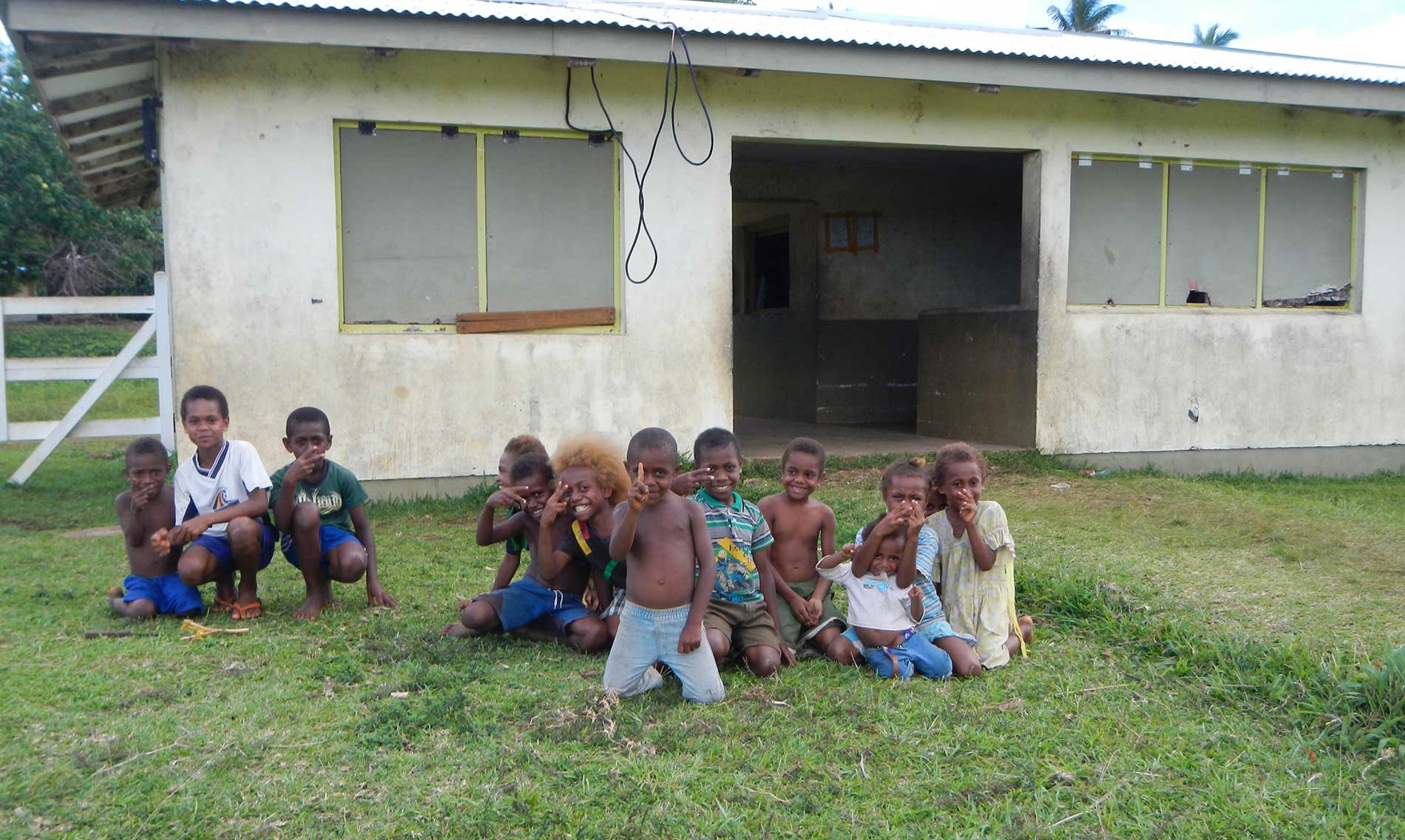 Island village children smiling in a row