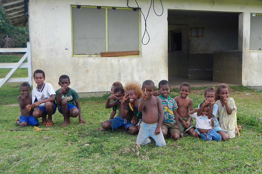 Island village children smiling in a row